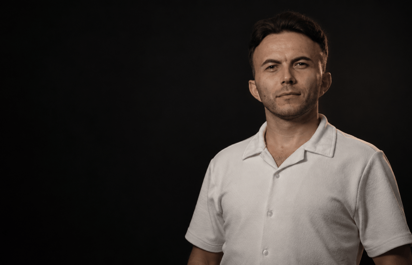 Muhammet Selim Yavuz in a landscape portrait against a dark background